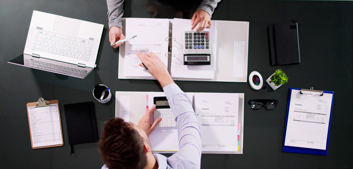 Two people reviewing financial documents at a desk